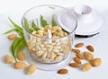 Blanched almonds In a blender with unshelled nuts. On white back Royalty Free Stock Photo