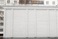 Blank ad space on a white brick wall in the street outside Royalty Free Stock Photo