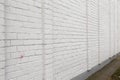 Blank ad space on a white brick wall in the street outside Royalty Free Stock Photo