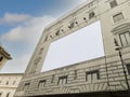 Blank advertising billboard on the scaffolding of the facade of an ancient building under restoration Royalty Free Stock Photo