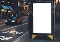 Blank advertising light box on bus stop, mockup of empty ad billboard on night bus station, template banner on background city Royalty Free Stock Photo