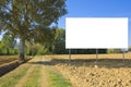 Blank advertising signboard in a countryside with lone tree and agricultural field