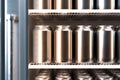 Blank Aluminum Beer or Soda Can With Droplets On Shelves In Refrigerator With Glass Door, 3d rendering. Minimalism