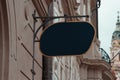 Blank Antique Black Store Signboard Mock up. Empty Shop Signage Template on Ancient Wall in European Town. Street sign