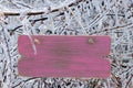 Blank antique wooden sign hanging on ice covered tree branches Royalty Free Stock Photo