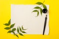 Blank artist sheet on bright yellow background with calligraphy pen and ink. View from the top. Artistic mockup template for your