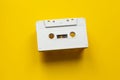 Blank audio cassette on a yellow background