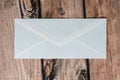 Blank back of a traditional white envelope for mailing over a dark wooden background Royalty Free Stock Photo