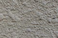 The blank background of the uneven rough wall is light gray yellow. The texture of a concrete, puttyed, plastered and Royalty Free Stock Photo