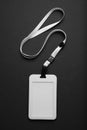 Blank badge mockup on black background. Plain empty name tag mock up hanging on neck with string Royalty Free Stock Photo