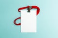 Blank badge mockup isolated on blue background. Plain empty name tag mock up with red string Royalty Free Stock Photo