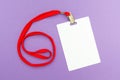 Blank badge mockup on purple background. Plain empty name tag with red string