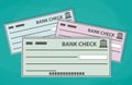 Blank bank checks isolated on green background Royalty Free Stock Photo