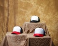 Blank baseball cap neatly displayed on a tiered stand. Royalty Free Stock Photo