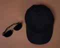 Blank baseball caps are used for design mockups. The hat on the side of an old camera and sunglasses. Royalty Free Stock Photo