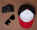 Blank baseball caps are used for design mockups. The hat on the side of an old camera and sunglasses. Royalty Free Stock Photo