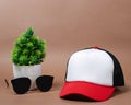 Blank baseball caps are used for design mockups. The hat on the side of an old camera and sunglasses. Royalty Free Stock Photo