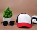 Blank baseball caps are used for design mockups. The hat on the side of an old camera and sunglasses. Royalty Free Stock Photo