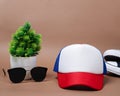 Blank baseball caps are used for design mockups. The hat on the side of an old camera and sunglasses. Royalty Free Stock Photo