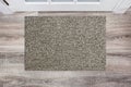 Blank beige woolen doormat before the white door in the hall. Mat on wooden floor, product Mockup