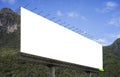 Blank big billboard against green mountain and blue sky background,for your advertising,put your own text here