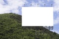 Blank big billboard against green mountain and blue sky background,for your advertising,put your own text here Royalty Free Stock Photo