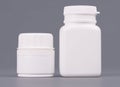 Blank big and medium size medicine white plastic packaging bottles for cosmetics, vitamins, pills or capsules. Packaging