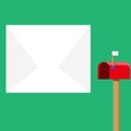 Blank Big White Envelope beside Red Mailbox with Small Flag Up. Open Color Postal Box in Loaf Shape Standing and Huge Royalty Free Stock Photo