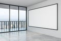 Blank big white mock up poster on white wall in modern empty spacious hall with city view Royalty Free Stock Photo