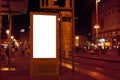 Blank billboard ad panel in urban setting at night Royalty Free Stock Photo