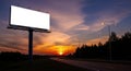 Blank billboard along a highway at sunset with dramatic sky Royalty Free Stock Photo