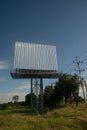 Blank billboard on the background of the road and blue sky. Royalty Free Stock Photo