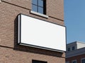 Blank billboard on brick building under clear blue sky Royalty Free Stock Photo