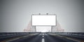A blank billboard on a bridge with red cables and road markings under a gray sky backdrop Royalty Free Stock Photo