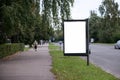 Blank Billboard on City Street. Transport and people in the background