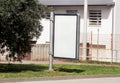 Blank billboard with copy space for your text message or content, public information board on flowerbed with green grass. Royalty Free Stock Photo