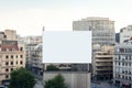 Historic cityscape crowned by a blank billboard frame, blending the old and the new