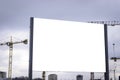 Blank billboard in front of industrial crane, building industrial