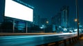 Blank billboard on the highway during the nightlight with city background, Blank screen for product display