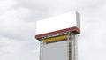 Blank billboard on the sideway in the park on rainbow overcast sky clouds background