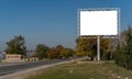 Blank billboard sign by empty highway through mountains landscape. Royalty Free Stock Photo