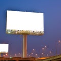 Blank billboard with white screen against blue sky at twilight time background. Copy space banner for advertisement. Royalty Free Stock Photo
