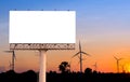 Blank billboard with wind turbine at sunset time for advertisem Royalty Free Stock Photo