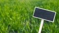 Blank Black billboard against green field landscape Empty mockup template Blackboard label at farm land. Copy space Royalty Free Stock Photo