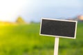 Blank Black billboard against green field landscape Empty mockup template Blackboard label at farm land. Copy space Royalty Free Stock Photo