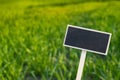 Blank Black billboard against green field landscape Empty mockup template Blackboard label at farm land. Copy space Royalty Free Stock Photo