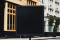 Blank black billboard on city street. Mock up, 3D Rendering, Black square signboard mockup outside of a building, AI Generated