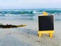 Blank Black board on a beach. Royalty Free Stock Photo