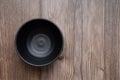 Blank black bowl or empty plate on rustic wooden table. top view. space for text