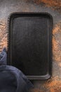 Blank black cast iron tray and textile napkin on the table, top view. Food background